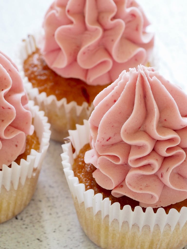 Three Baked Muffin With Strawberry Filling on Top